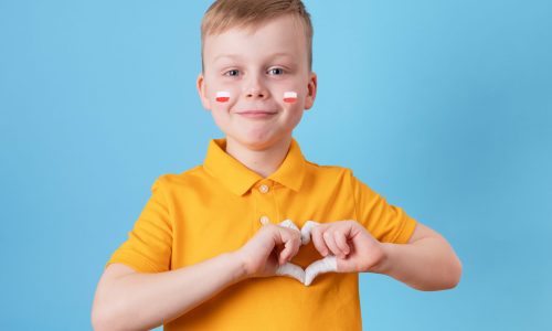 child-showing-his-heart-as-sign-poland-s-support-ukrainian-people